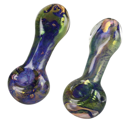 A close-up, angled view of the Spattered Fumed Hand Pipe, showcasing its speckled glass finish and curved form.
