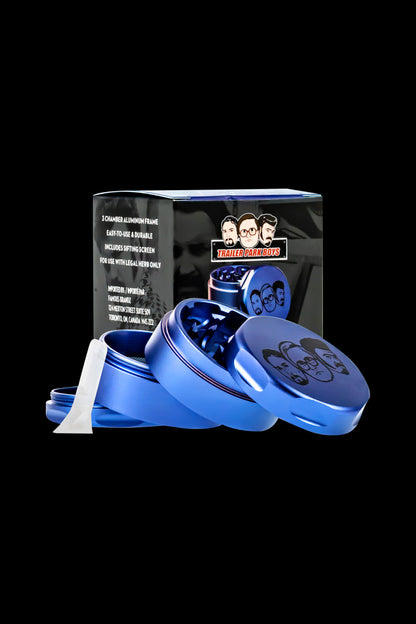 Blue metal grinder with “Trailer Park Boys” branding, partially open with cannabis visible inside."