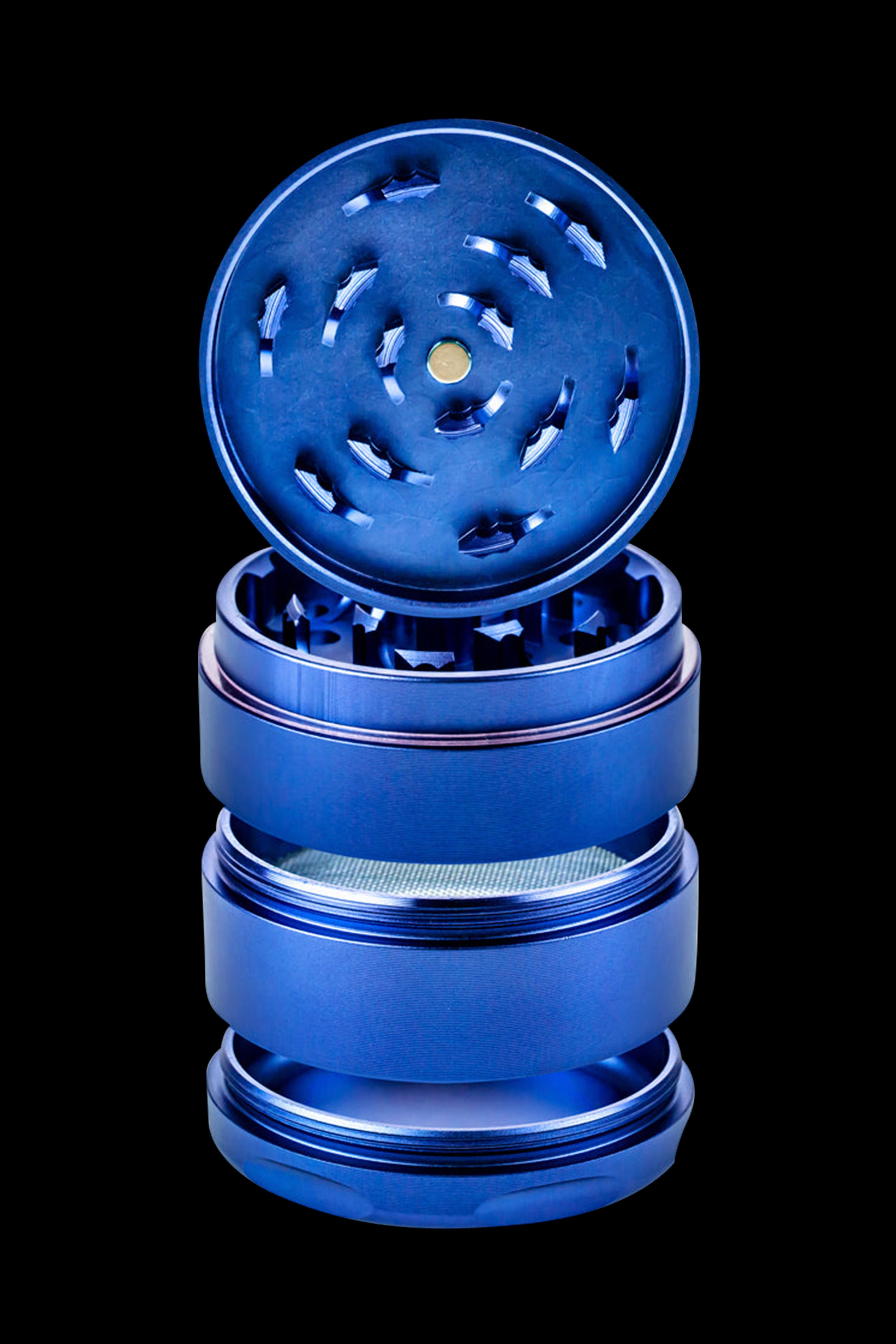 Blue four-piece metal grinder for cannabis.