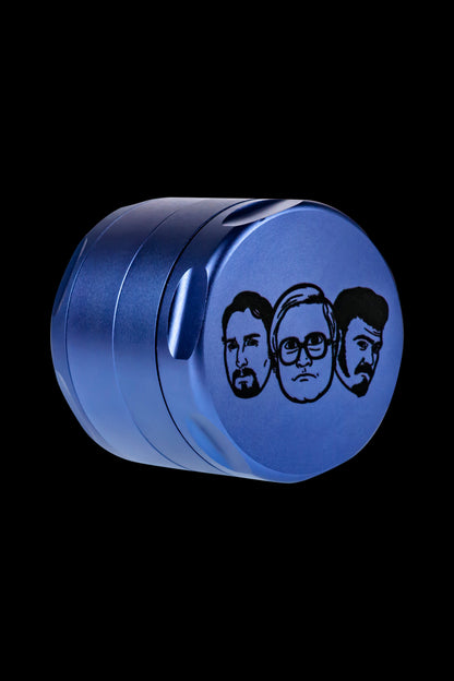 Blue metal grinder with portraits of the members of ZZ Top etched on the side, isolated on a black background.
