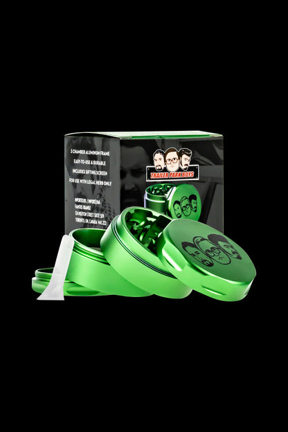 Green grinder with “Trailer Park Boys” branding, open to reveal ground cannabis inside.