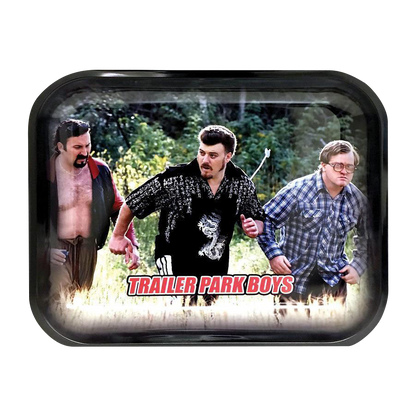 A slightly angled overhead view shows the “Trailer Park Boys “Hustle” Rolling Tray” featuring a humorous scene of characters amid lush greenery.