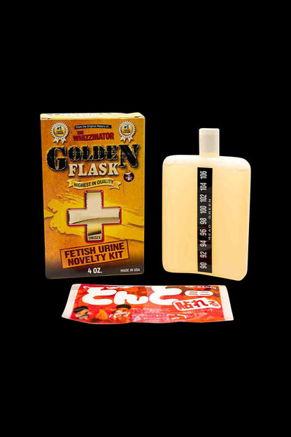 Front view of the golden The Whizzinator Golden Flask Fetish Urine, displayed with its packaging against a black background.
