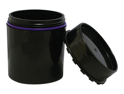 A slightly angled view of the open “Time Capsule” Sealable Storage Device, showing its dark interior and simple cylindrical form.