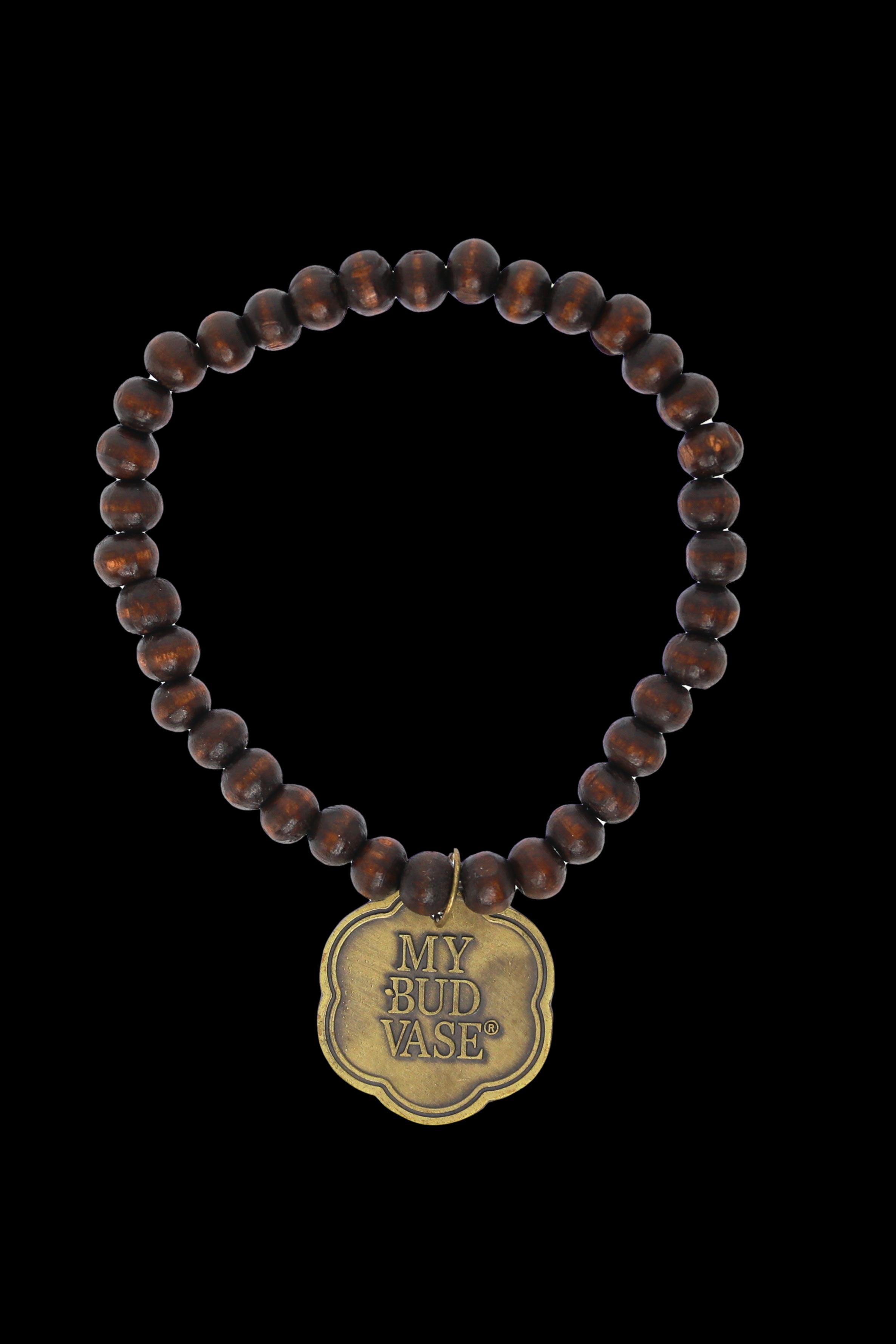 Brown beaded necklace with a brass “My Bud Vase” pendant.