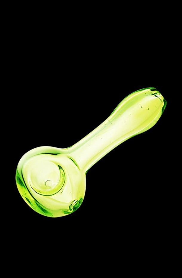 A side view of the translucent Spring Green Spoon Pipe, showing its curved shape and simple glass construction.