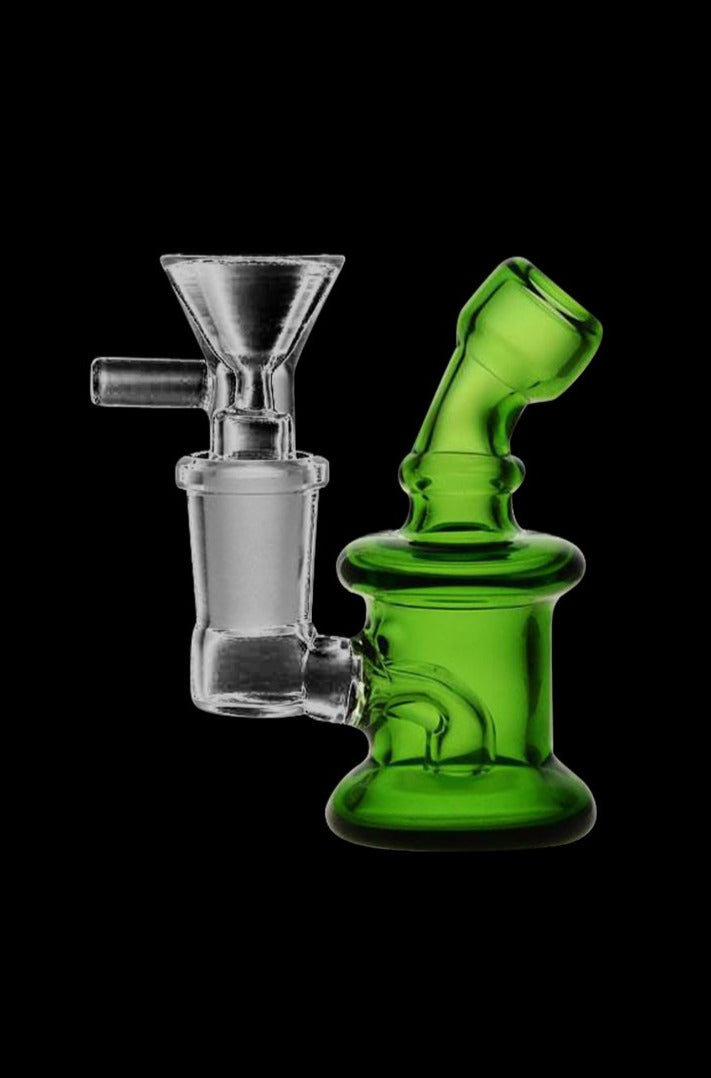 A close-up, angled view of the Super Nano Travel Rig Bubbler in clear glass, highlighting its compact size and smooth curves.