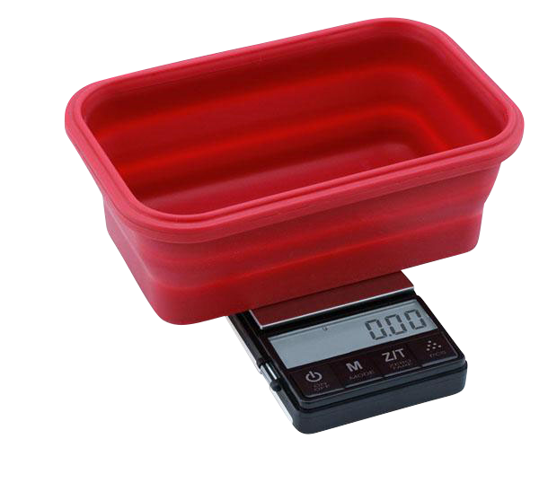 A close-up, angled view of the Truweigh Crimson Collapsible Bowl Scale, displaying a digital readout on its small, red weighing platform.