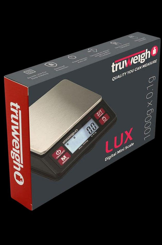 A close-up, angled view of the Lux Digital Mini Scale with a black face and silver body, displaying a digital readout.