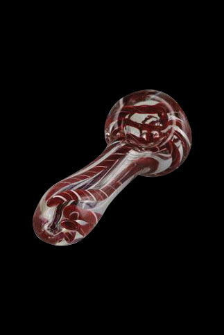 Red and white swirled glass pipe against a black background.