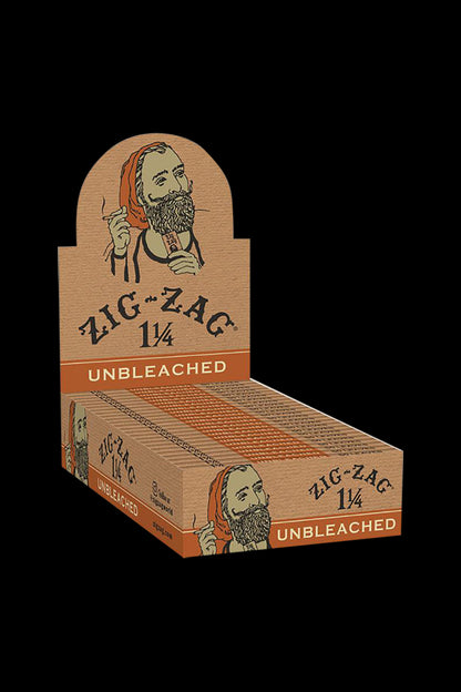 Front view of the Zig Zag 1 1/4" Unbleached Rolling Papers 24-pack, displaying the branded packaging with a vintage-style illustration.