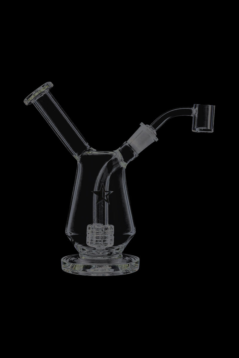 Front view of the Famous X Drip Dab Rig sitting on a black background, showing its angled neck, percolator and star logo.