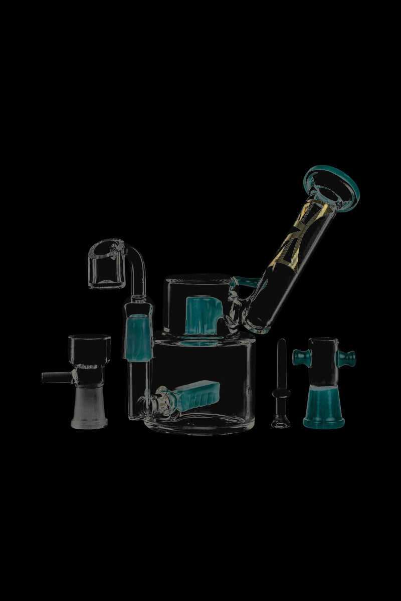 A detailed, angled view of the Evolution Morning Glory Sidecar Dab Rig in clear glass, with visible joints and a compact design.