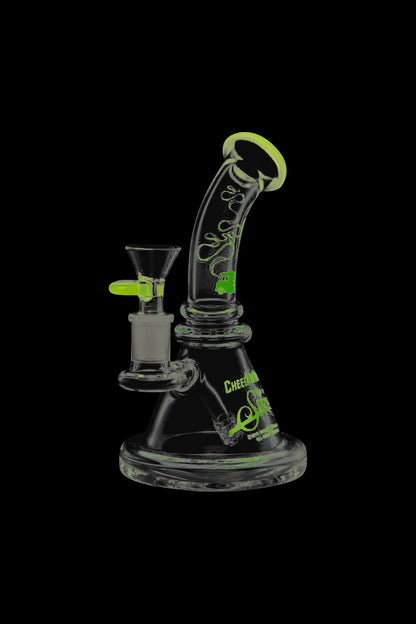 Front view of the Cheech & Chong Strawberry Mini Beaker Bong, a small, clear glass bong against a black background.