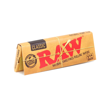 Close-up of a pack of RAW Classic 1 1/4" Rolling Papers, displaying the brand logo on a neutral background.