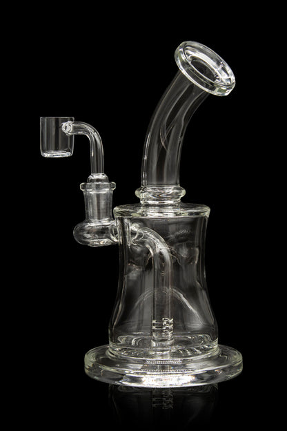 Clear glass dab rig with intricate percolator and quartz nail, isolated on black.