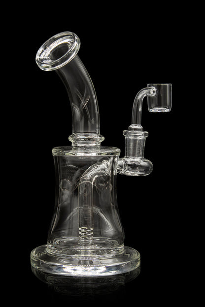 Clear glass dab rig with a bent neck and quartz banger, isolated on a black background.