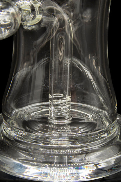 Clear glass dab rig with swirling vapor, showcasing intricate glasswork.