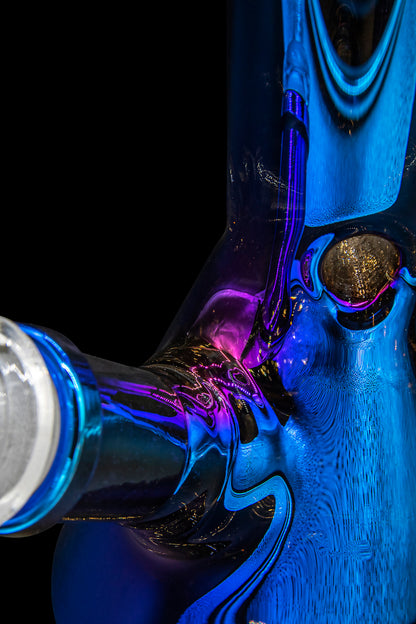 Close-up of a colorful, intricately designed glass water pipe against a black background.