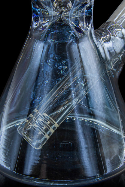 Blue glass cannabis water pipe with intricate swirling patterns.