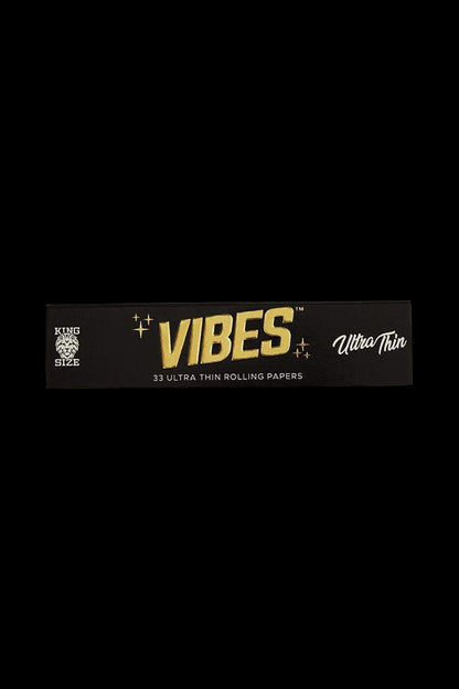 A centered, close-up shot of VIBES King Size Slim Ultra Thin Rolling Papers in their branded packaging against a dark background.