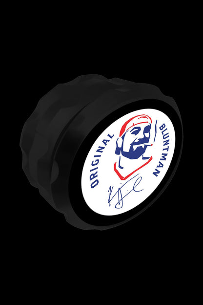 Close-up view of the Jay and Silent Bob Bluntman Grinder, showcasing its circular metal construction with a dark finish.