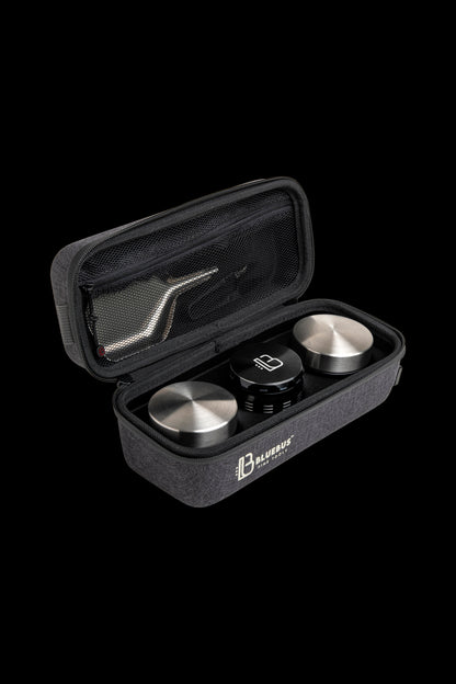 Open black carrying case displaying cannabis concentrate containers and tools, branded "Bluebus Fine Tools."