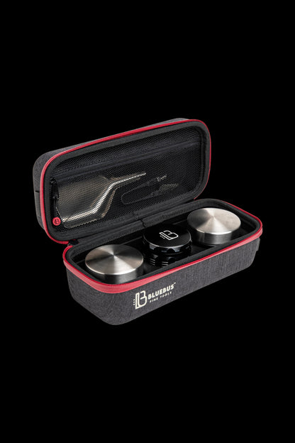 Black and red carrying case open, displaying a cannabis smoking device and accessories inside.