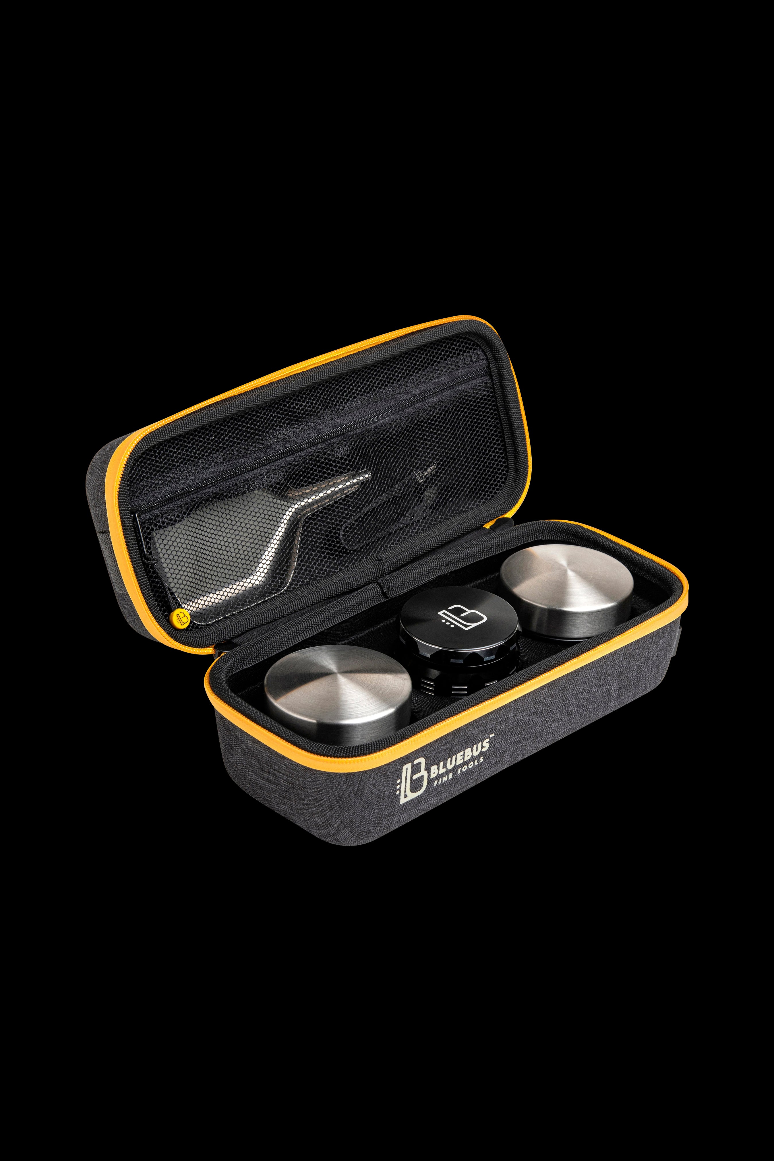 Open gray and black carrying case with two silver cannabis concentrate containers inside, branded “Bluebus Fine Tools.”