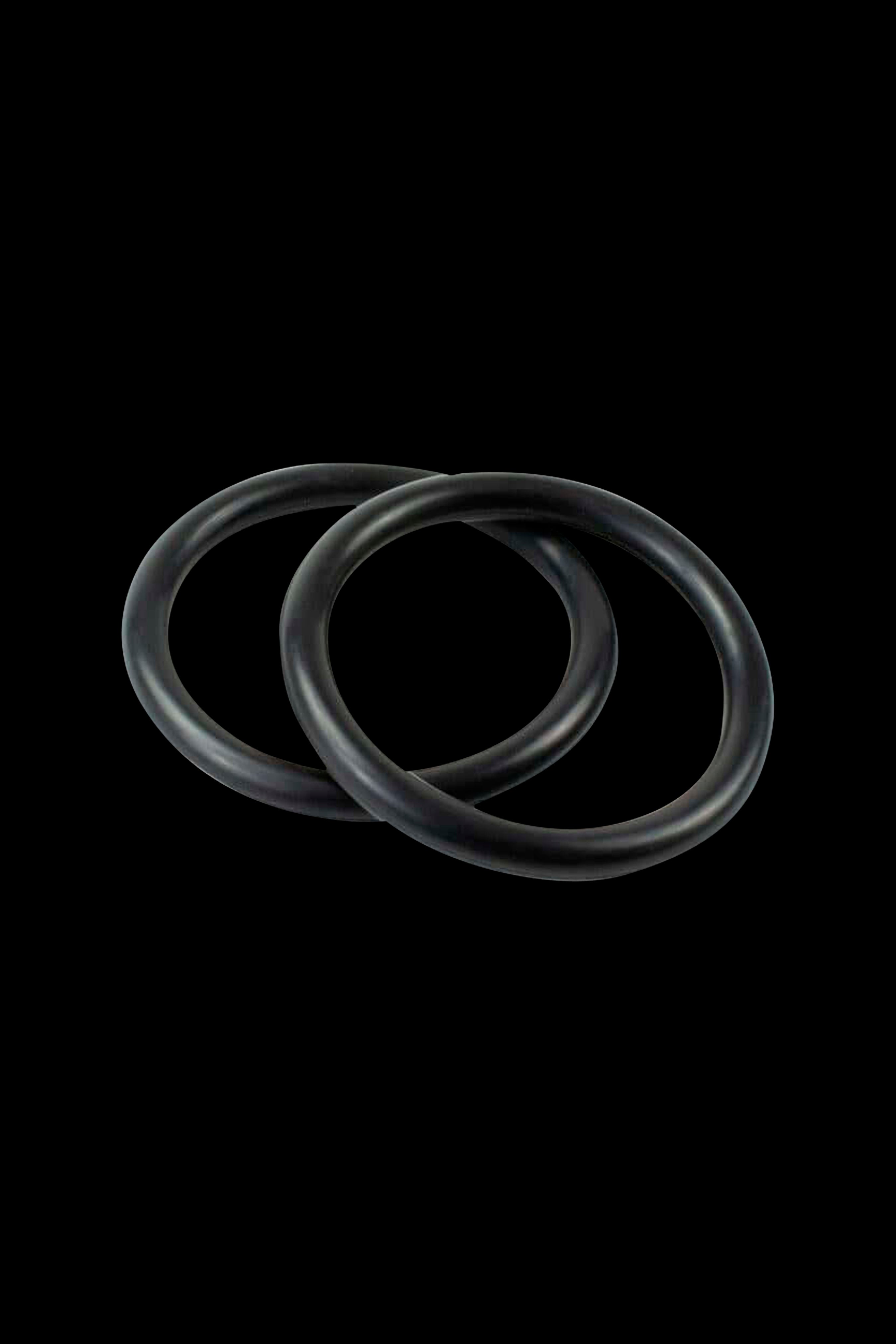 Black silicone rings against a black background.