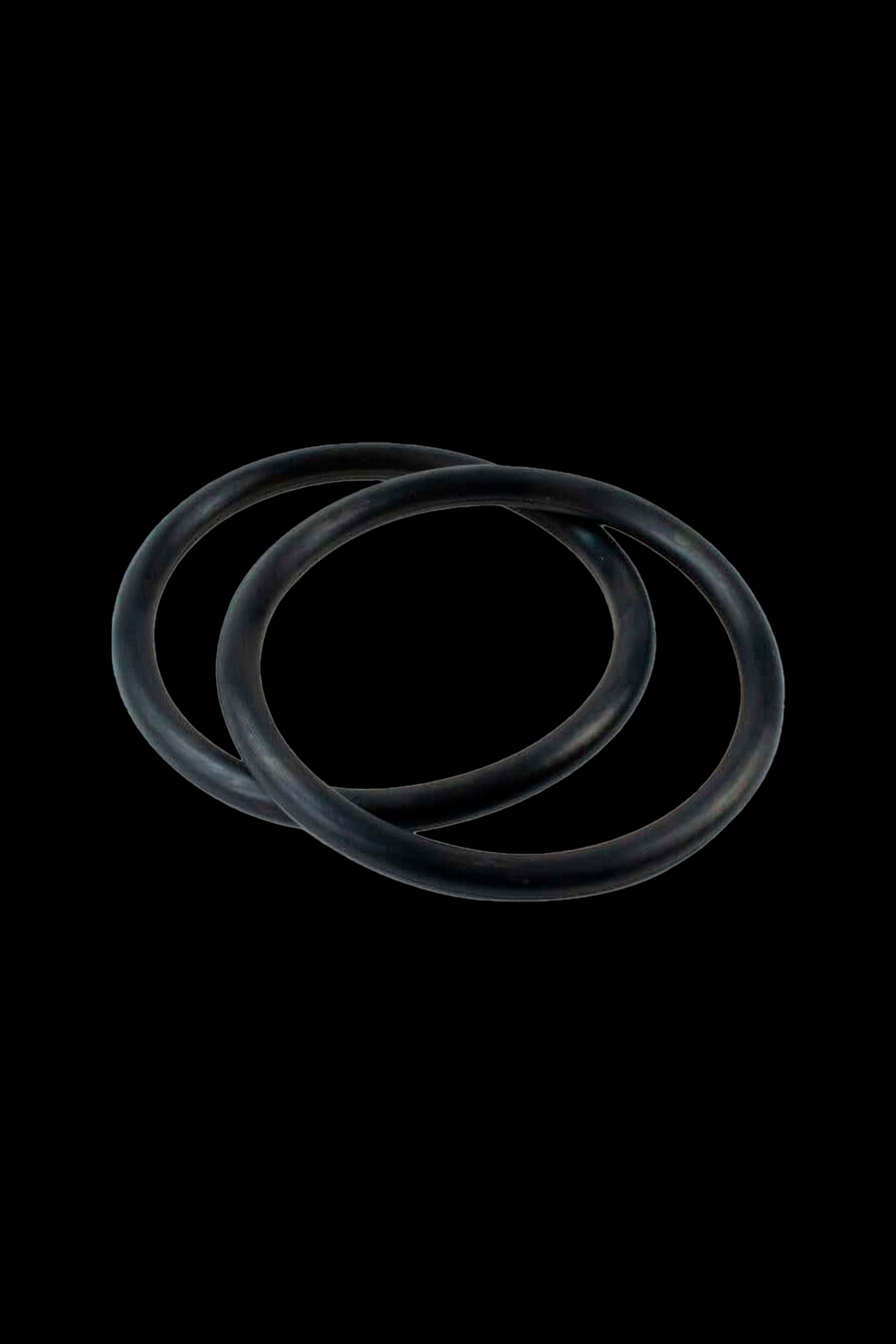 Black silicone replacement o-rings for cannabis accessories against a black background.