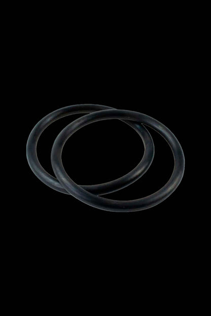 Black silicone replacement o-rings for cannabis accessories against a black background.