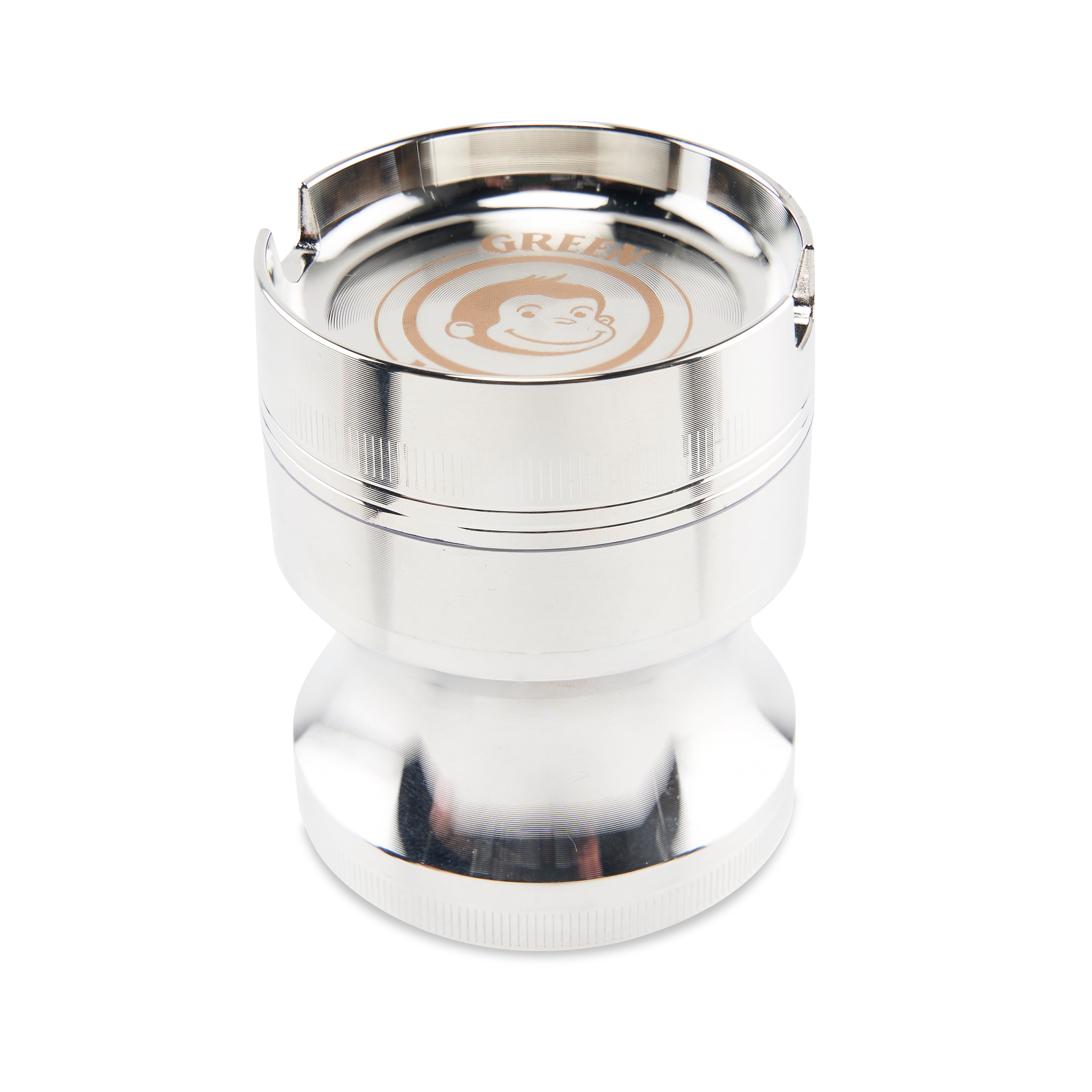 Close-up top-down view of the metallic Green Monkey Chacma Grinder with Ashtray showing its shiny rim, slot notches, and stamped monkey logo.