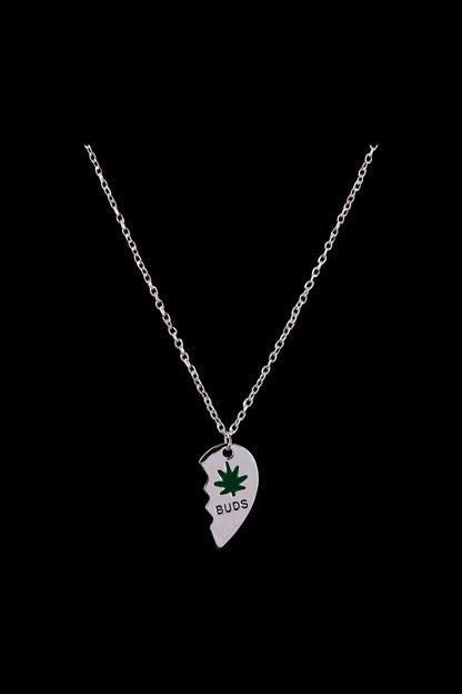 A close-up of the DankStop Best Buds Sharable Necklace, featuring two interlocking pendants on a delicate silver chain.