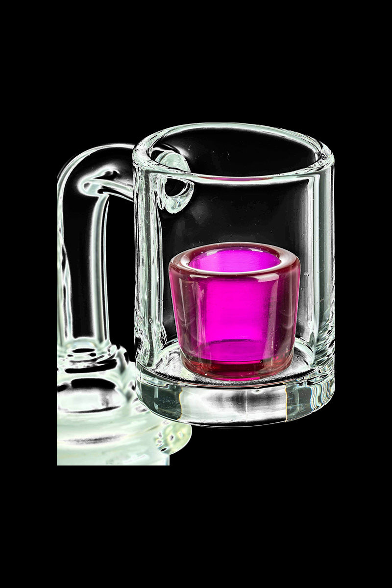 A close-up, angled view of the E-Rig Compatible Ruby Quartz Cup Insert, showcasing its vibrant ruby color within a clear glass container.