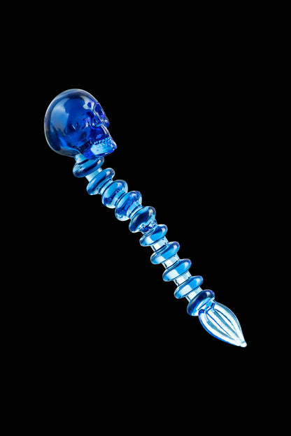 A detailed close-up of the Fatality Dabber, showing its glass construction and intricate sculpted design.
