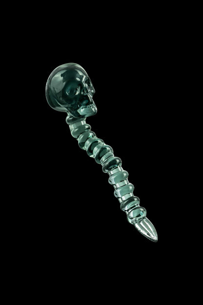 A close-up of the Fatality Dabber, showcasing its sculpted, emerald-green glass design against a dark background.