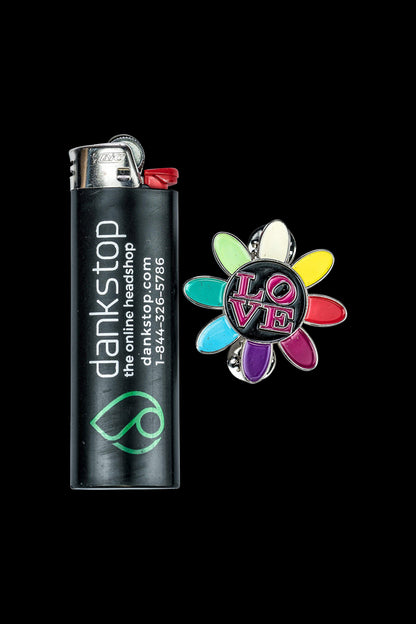 A close-up of the Love Daisy Metal Pin displayed against a dark background, showcasing its detailed floral design.