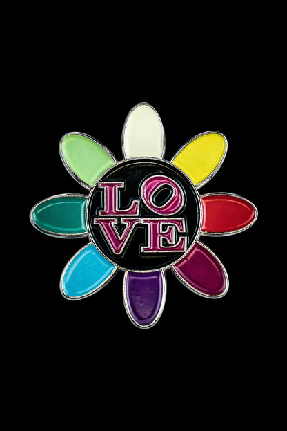 A close-up of the Love Daisy Metal Pin, showcasing its colorful petal arrangement with a metallic sheen.