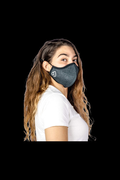 A woman wearing the Reversible Cloth Mask in a close-up, front-view shot with soft lighting.