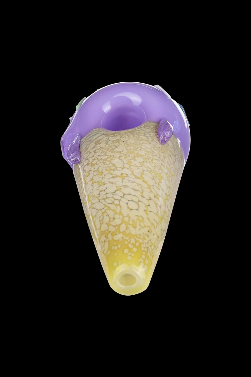 A close-up, angled view of the Single Scoop Ice Cream Spoon Pipe, showcasing its sculpted glass form and vibrant color scheme.