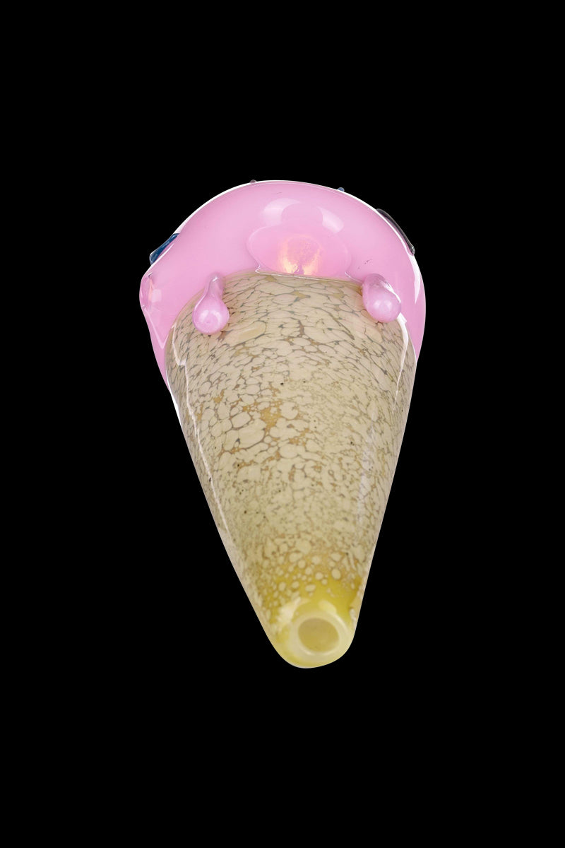 A side view of the Single Scoop Ice Cream Spoon Pipe, showcasing its textured, beige glass construction.