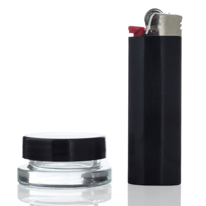 A high-angle view of the 9mL Dip Devices glass container, reflecting light on its smooth, clear surface.
