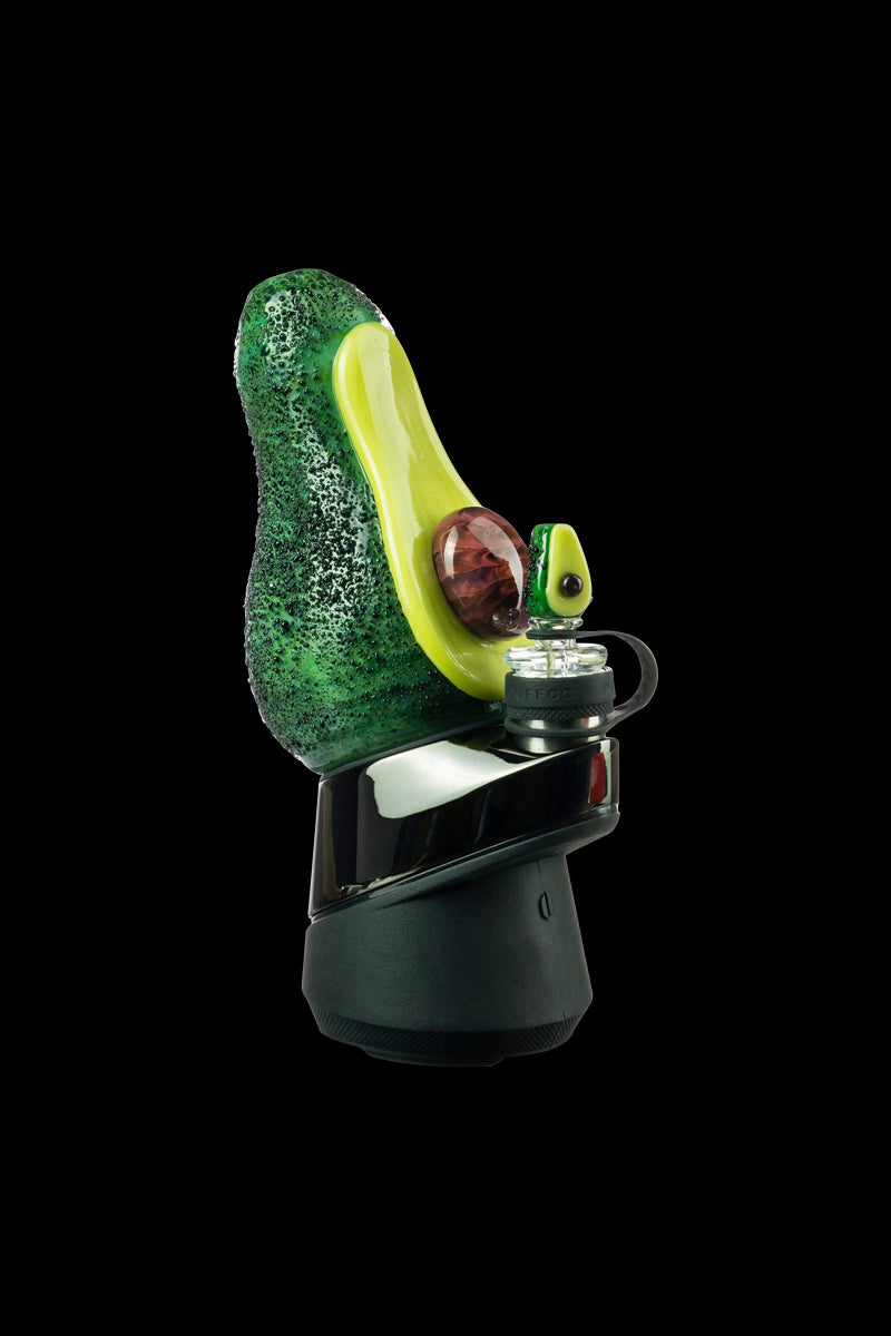 A close-up, angled view showcases the Empire Glassworks Avocadope Carb Cap for Puffco Peak, featuring a green and tan swirl pattern.