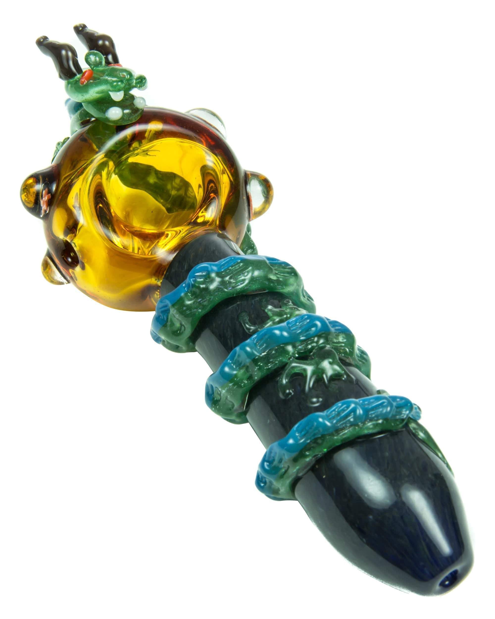 A close-up view of the Empire Glassworks Dragon Sphere Small Spoon Pipe, displaying a colorful glass design.