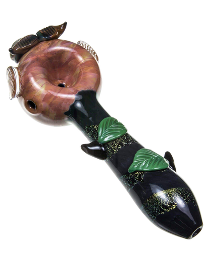 A detailed side view of the Empire Glassworks "The Owl" Mini Glass Spoon Pipe, featuring sculpted feather details and a rich amber hue.