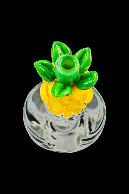 A close-up shot of the Pineapple Carb Cap for Puffco Peak, showing its textured, rounded top against a dark background.