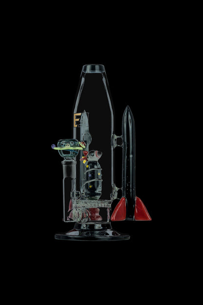 A studio shot displays the Empire Glassworks Galactic Flagship Bong, showcasing its detailed glasswork and unique, sculptural form.