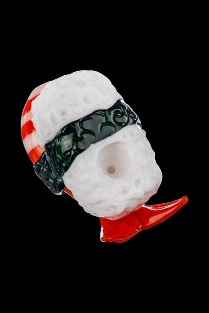 A slightly angled view of the Empire Glassworks Shrimp Nigiri Sushi Hand Pipe, resembling a miniature sushi roll in white and pink glass.