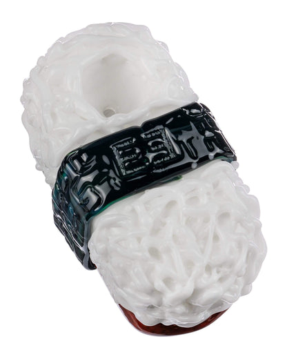 A close-up studio shot of the Empire Glassworks Spam Musubi Sushi Hand Pipe, resembling a colorful sushi roll.